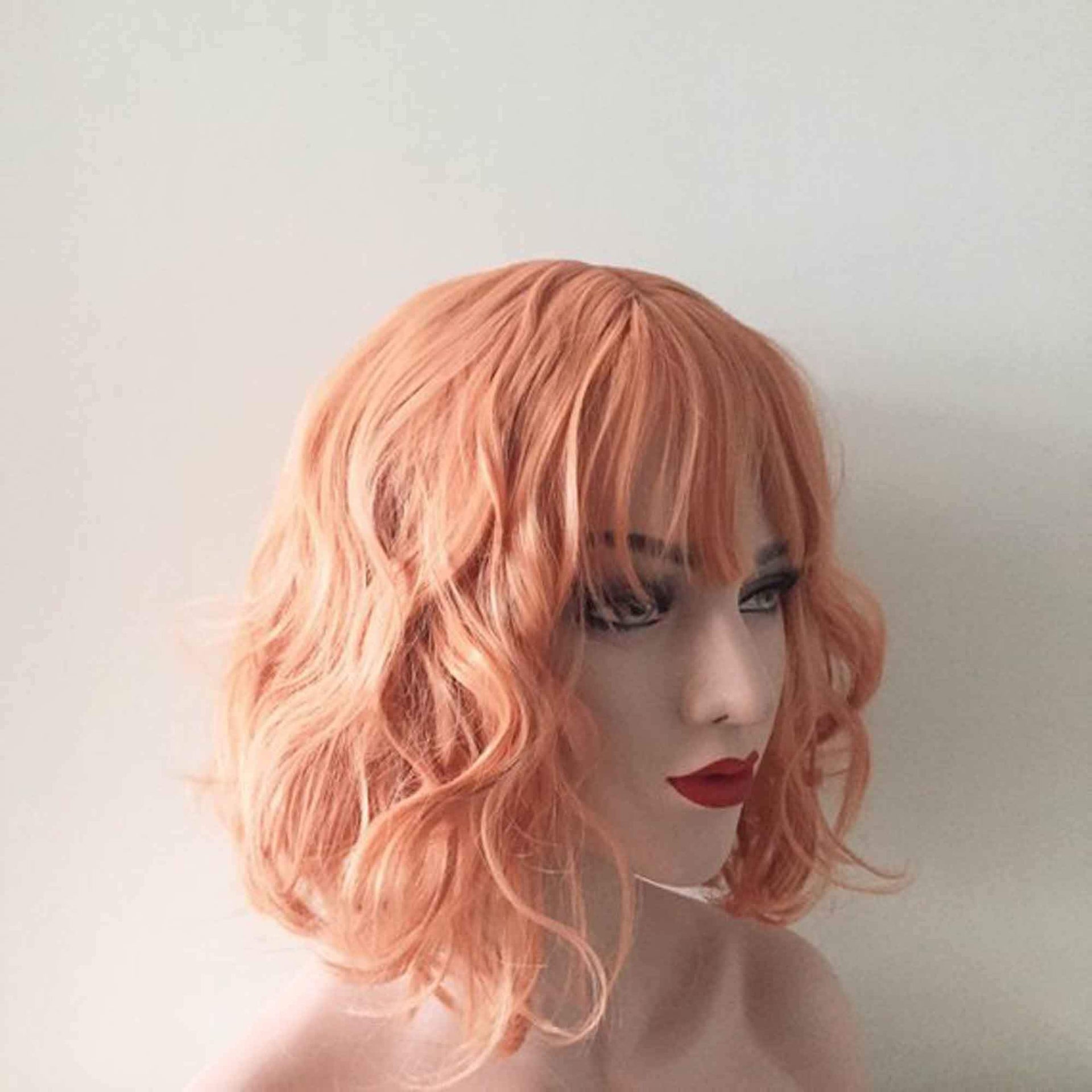 nevermindyrhead Women Orange Short Curly Bob Fringe Bangs Wig